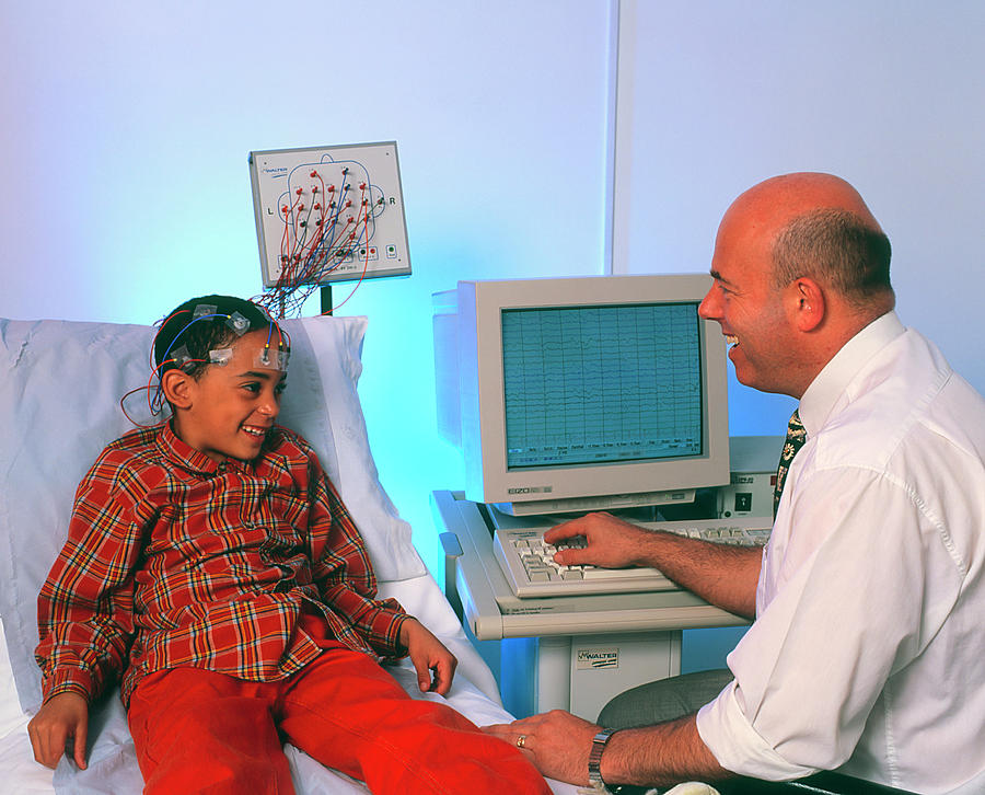 Doctor Monitors Boys Brain Activity By Eeg Photograph by Science Photo Library