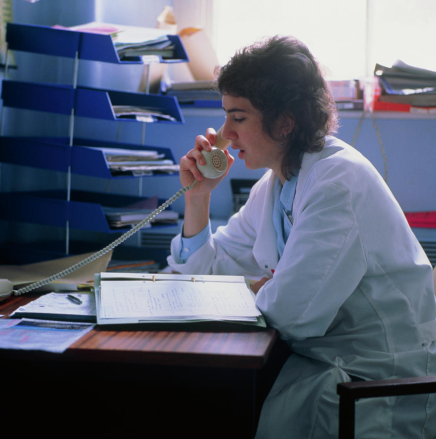 Doctor On Telephone About A Patients Record Photograph by Ron Sutherland/science Photo Library