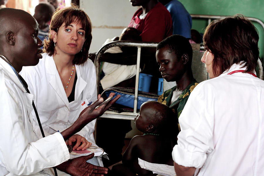 Doctors In A Ugandan Refugee Camp Photograph by Mauro Fermariello/science Photo Library