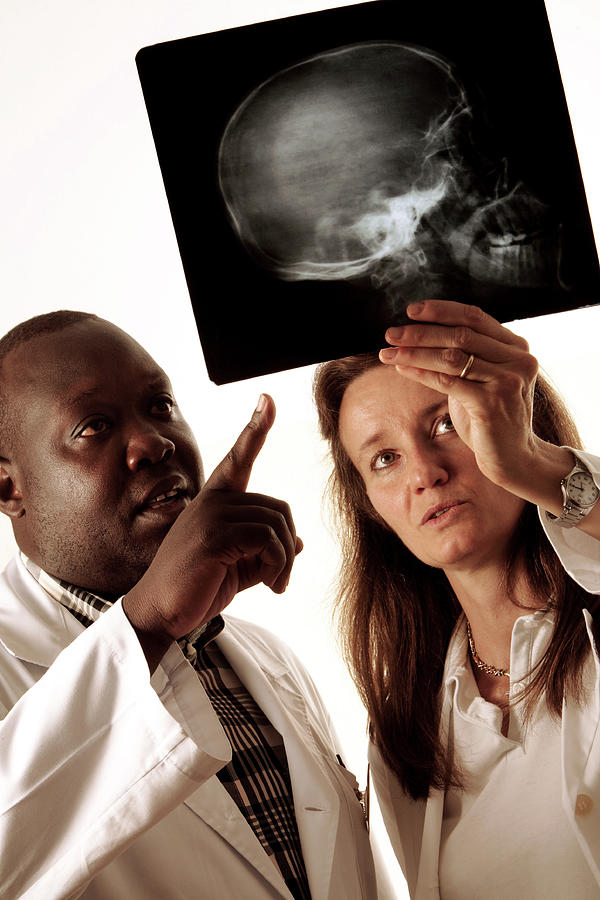Doctors Looking At An X-ray Photograph by Mauro Fermariello/science Photo Library
