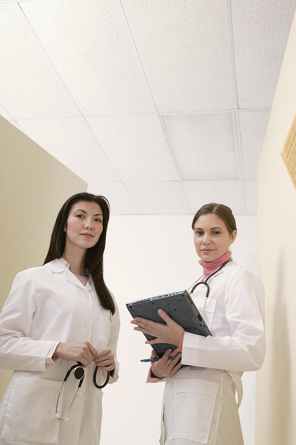 Doctors standing in hallway Photograph by Comstock Images
