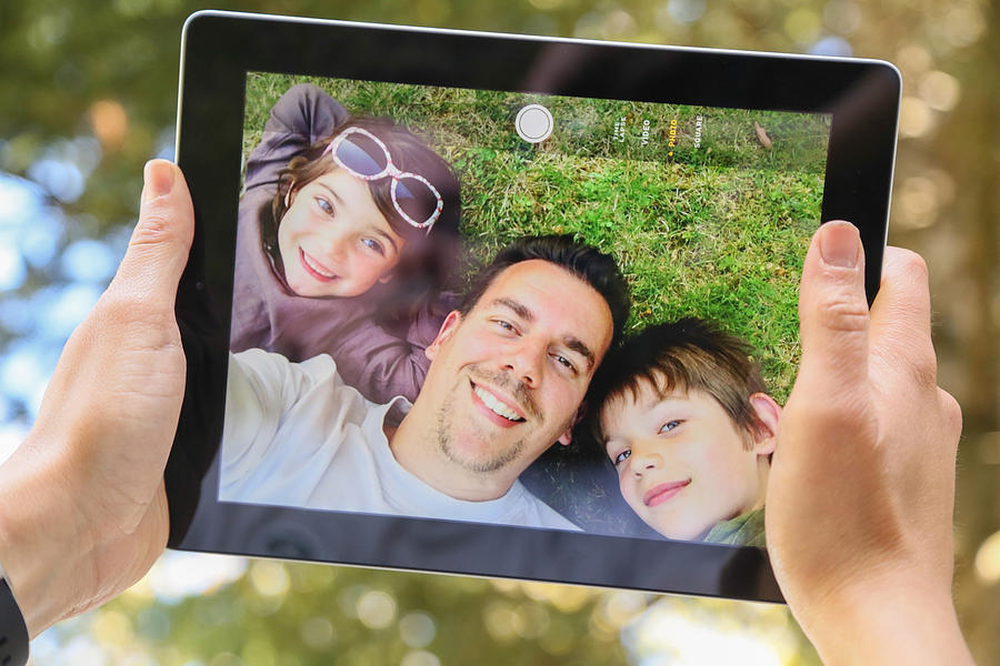 Doing a selfie with my family on tablet Photograph by Artur Debat