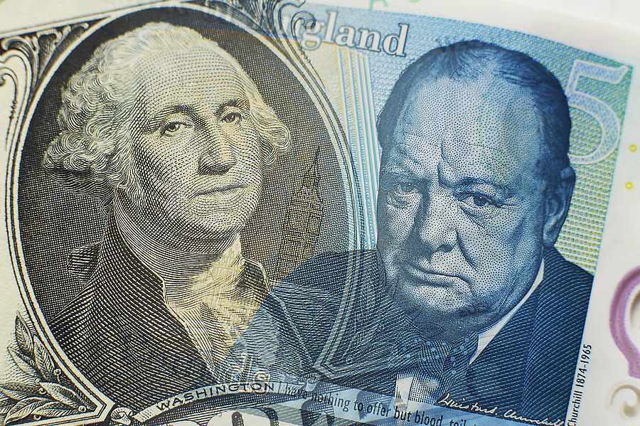Dollar and Sterling close-up Photograph by John Lamb