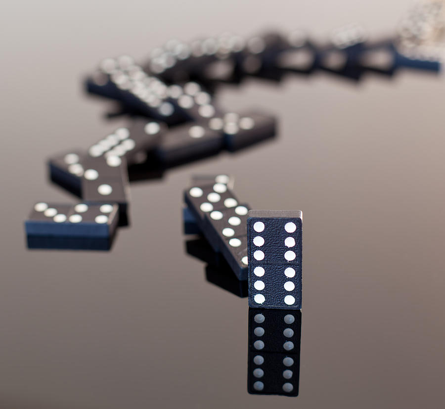 Dominoes collapsed on reflective surface Photograph by Steven Heap