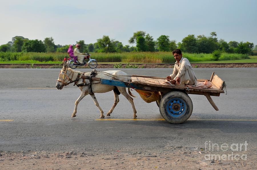 Donkey cart driver and motorcycle on Pakistan highway Photograph by Imran Ahmed