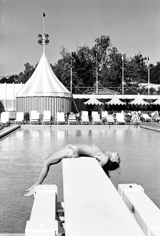 Donna Garrett Lying On A Diving Board Photograph by William Connors