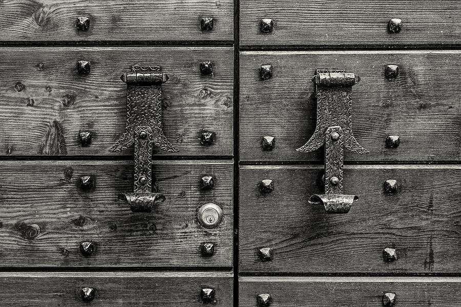Doorknockers and nails Photograph by Roberto Pagani