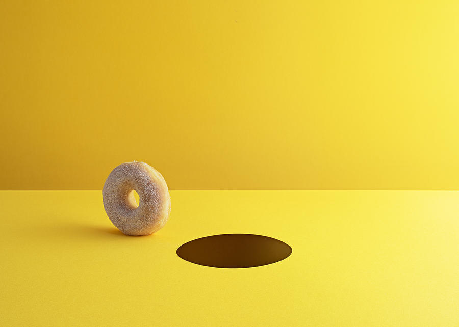Doughnut and hole on yellow ground Drawing by Westend61