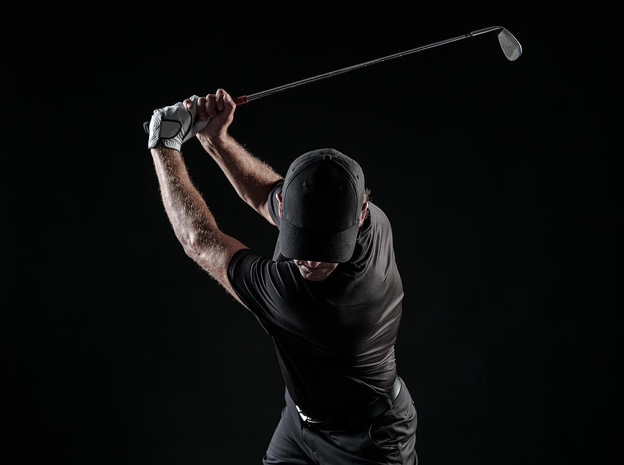 Dramatic Image Of A Male Golfer At The Top Of His Swing Photograph by MichaelSvoboda