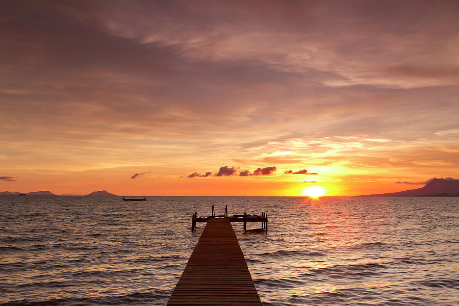 Dramatic Sunset On A Wooden Pier In Asia Photograph by Joakimbkk