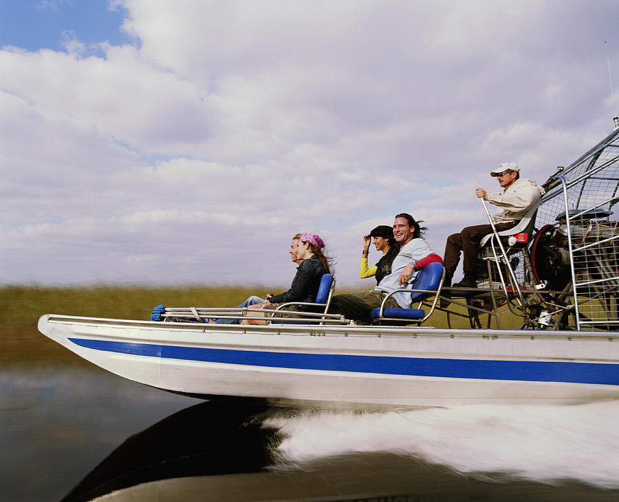 Driver and four passengers on airboat, side view Photograph by Ryan McVay