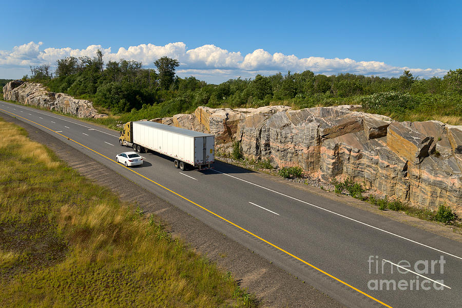Driving north through Canadian Shield Photograph by Les Palenik