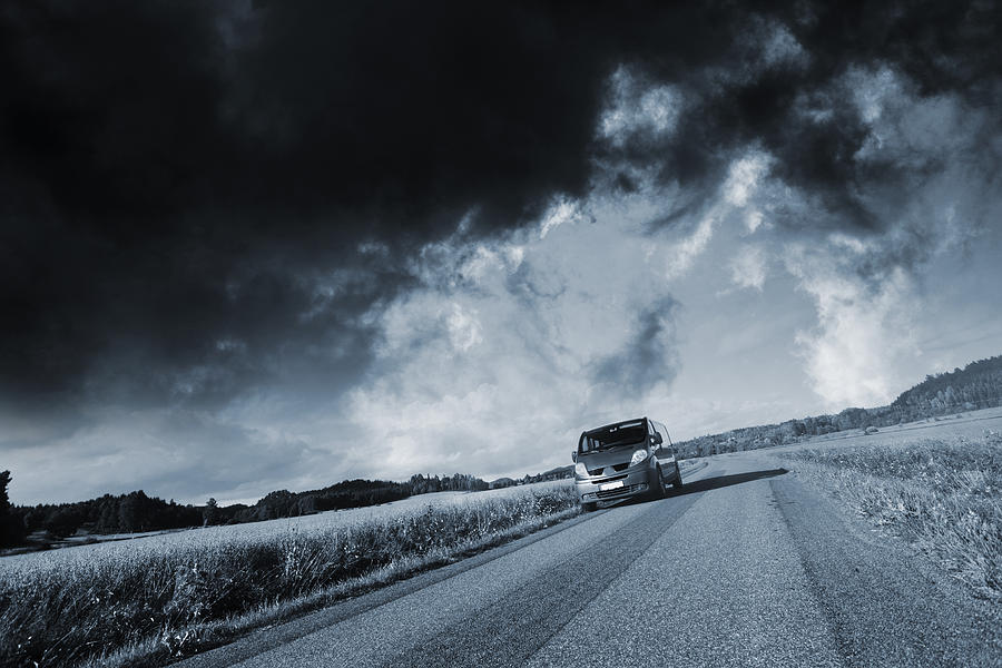 Driving Under A Stormy Sky Photograph by Christian Lagereek