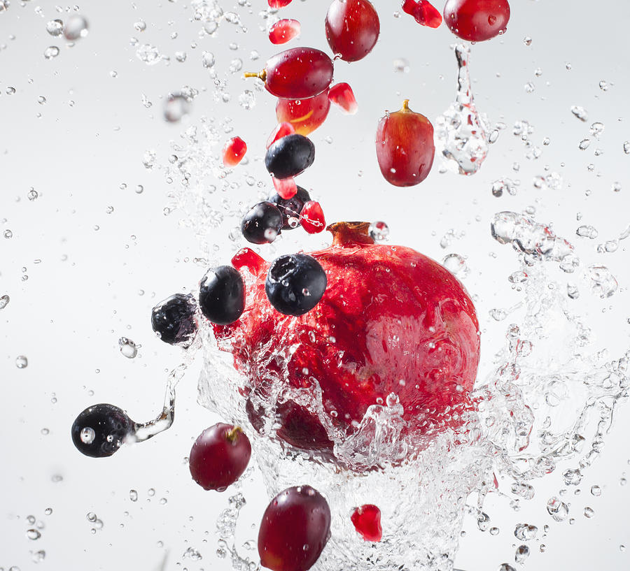 Droplets splashing on fruits Photograph by Mike Kemp