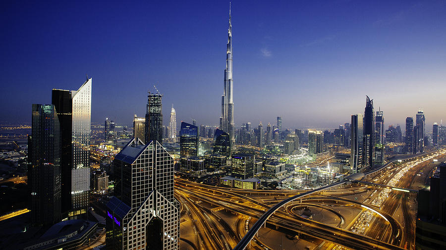 Dubai sky line with traffic junction and Burj Khalifa Photograph by Tempura