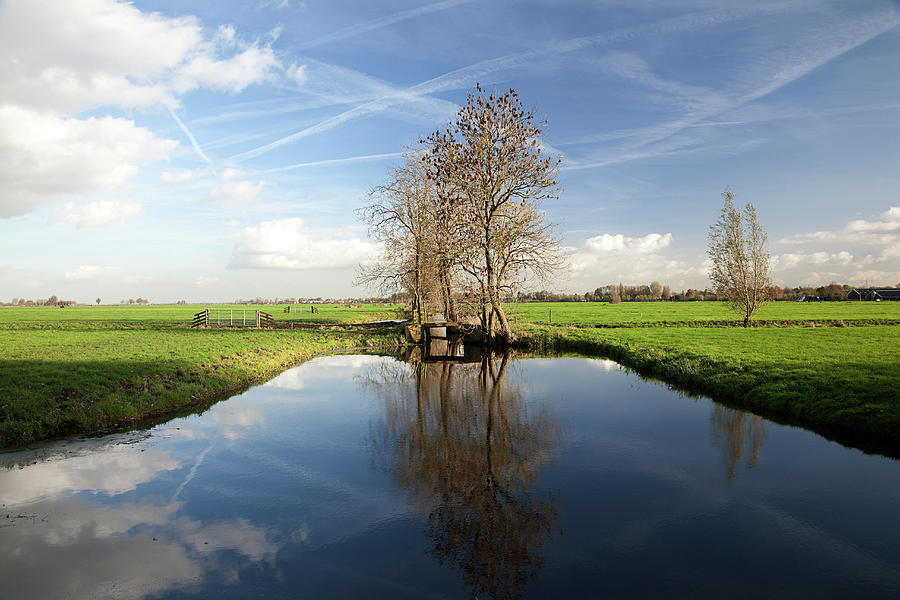 Dutch Polder With Wide Ditch And Trees Photograph by Roel Meijer