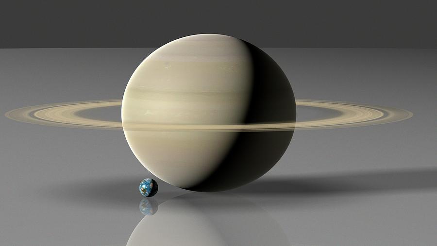 Earth Compared To Saturn Photograph by Mark Garlick/science Photo Library