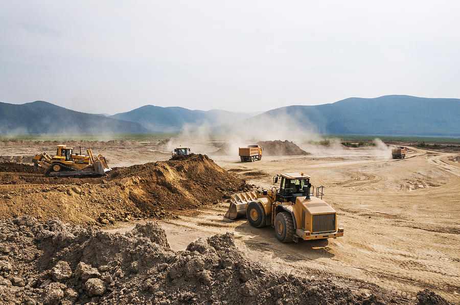 Earthwork, working machinery on a summer day Photograph by Pro-syanov