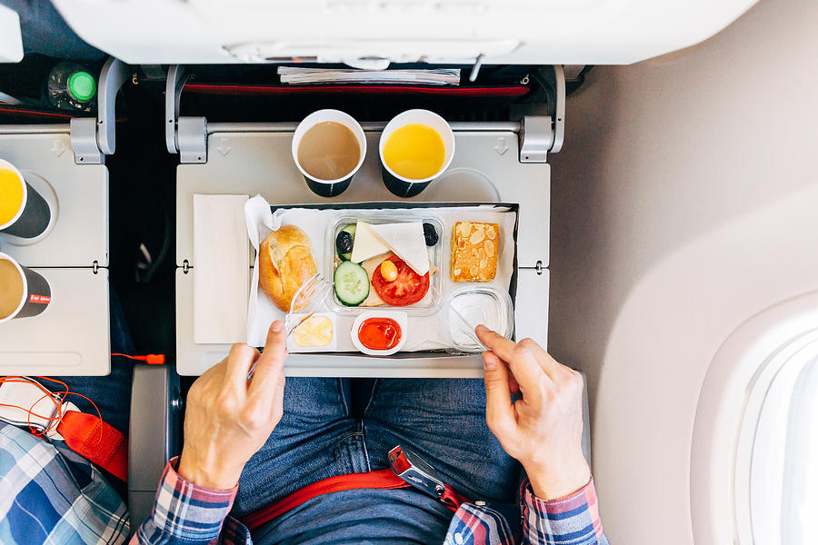 Eating airplane food during a flight, personal perspective directly above view Photograph by Alexander Spatari