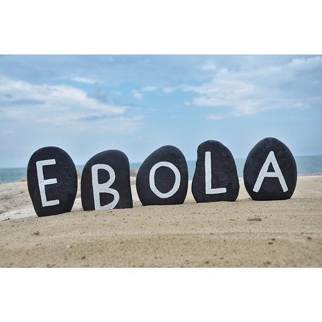 Stones Photograph - Ebola Virus Name On Black Stones by Adriano La Naia