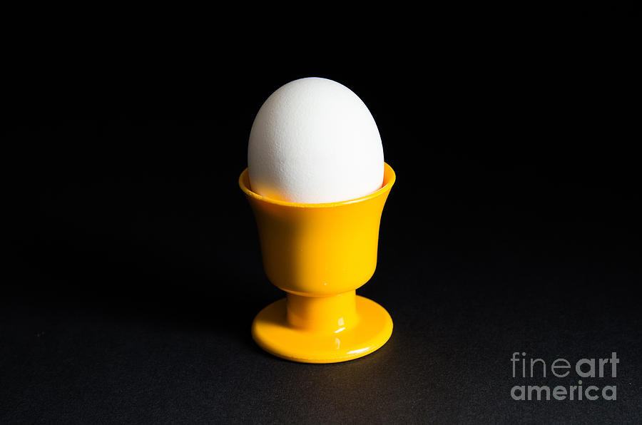 Easter Photograph - Egg in cup at black background by Kennerth and Birgitta Kullman