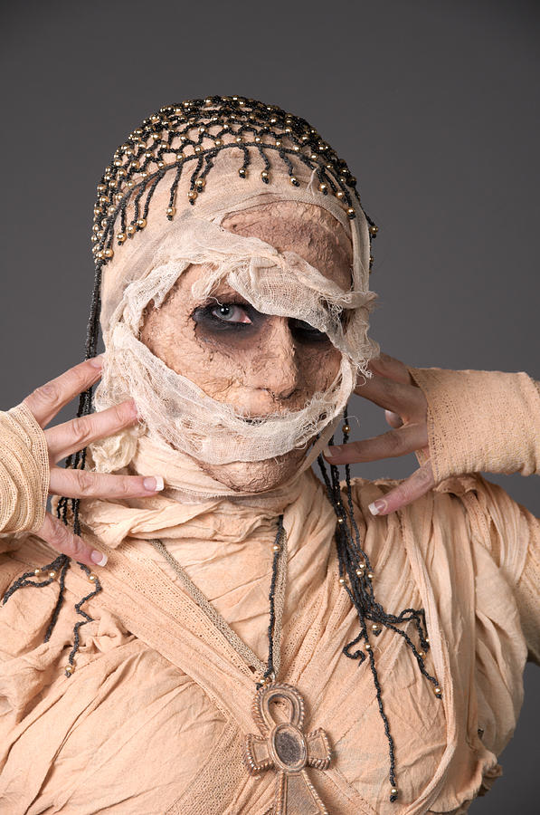 Egyptian mummy touching bandaged face Photograph by ValaGrenier