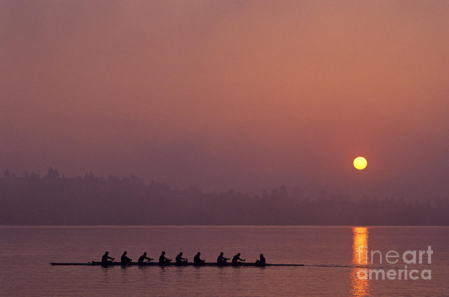 Eight man crew on Union Bay silhouetted at sunrise  Photograph by Jim Corwin