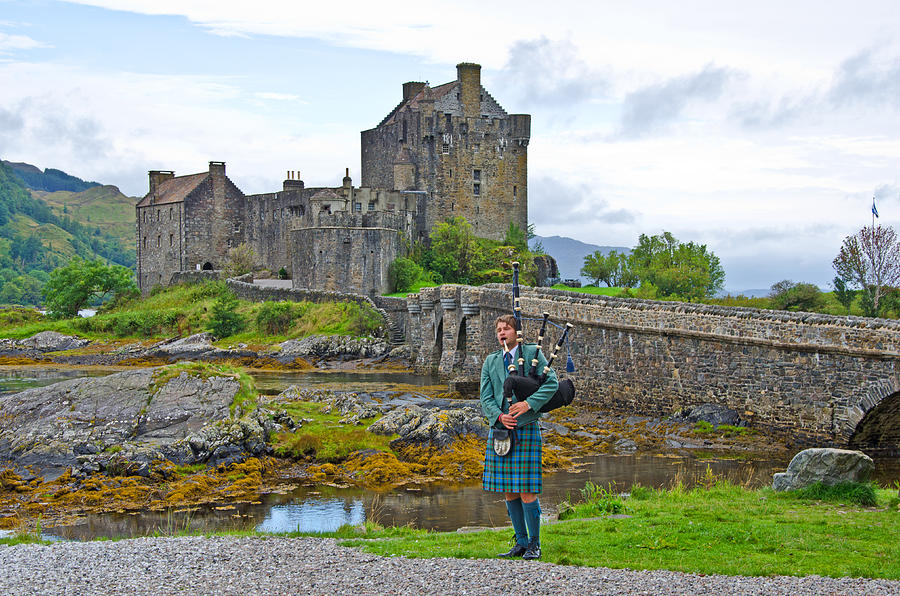 Eilean Donan Castle and the Lone Piper Photograph by Chris Thaxter