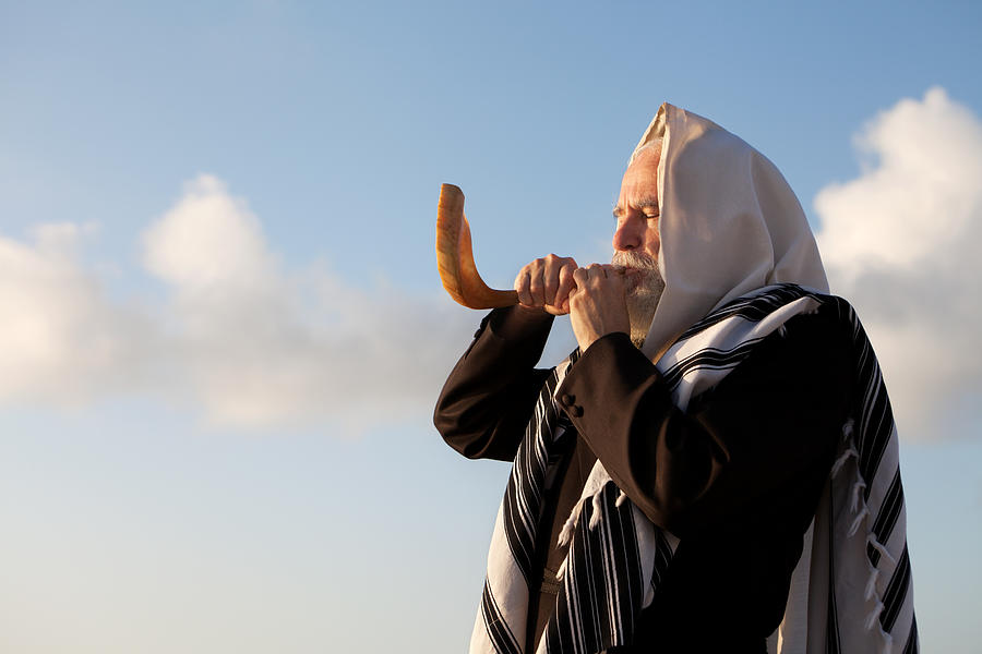 Elder Jewish man blowing a Shofar on Rosh Hashanah Photograph by Tovfla