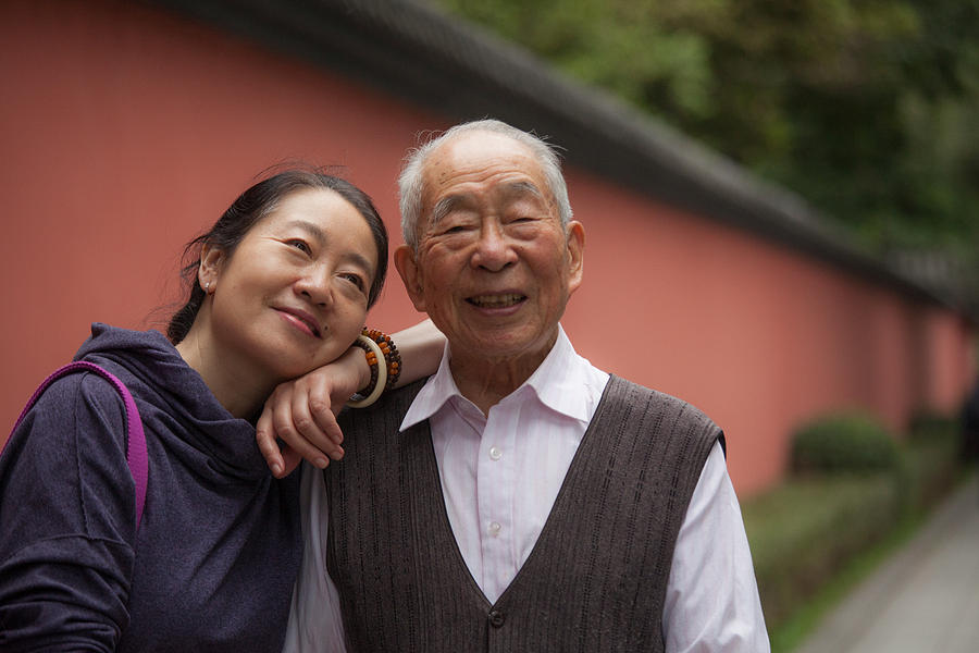 Elderly father and his middle aged daughter Photograph by XiFotos
