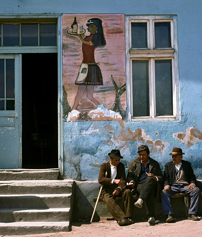 Elderly men chating on a bench in front of a cafe. Serbia Photograph by Juan Carlos Ferro Duque