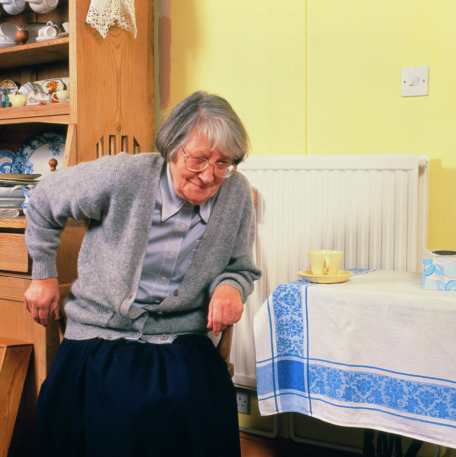 Elderly Woman Has Difficulty Rising From Chair Photograph by Chris Priest/science Photo Library