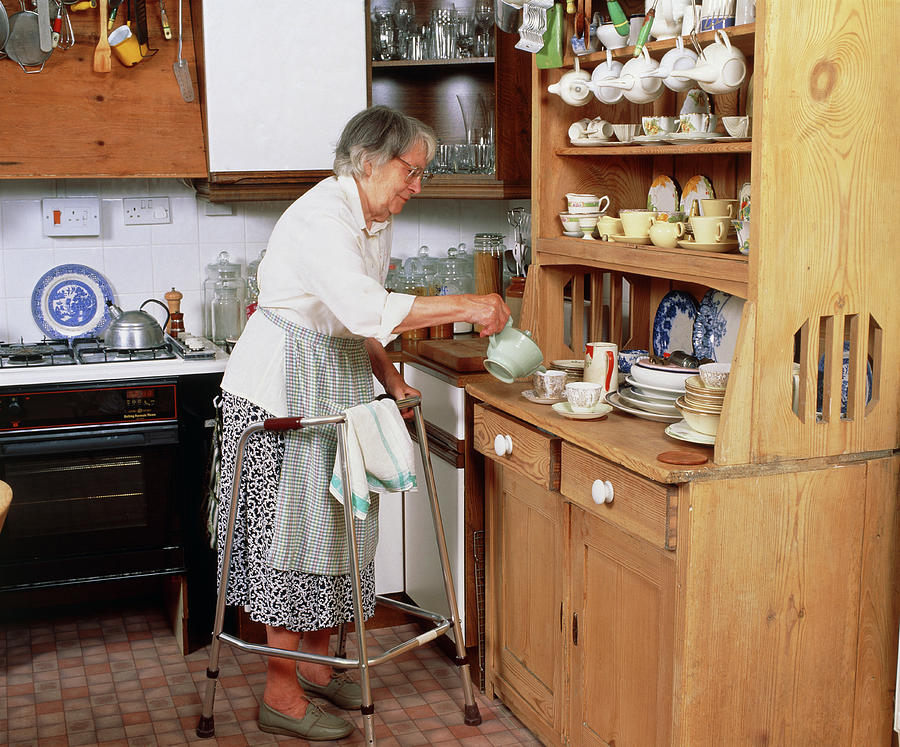 Elderly Woman With Zimmer Frame Makes Cup Of Tea Photograph by Chris Priest/science Photo Library