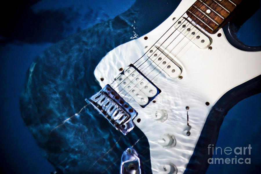 Electric guitar underwater  Photograph by Noam Dinar
