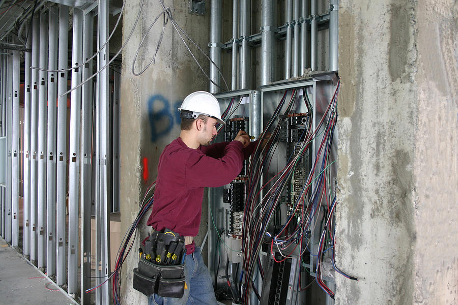 Electrician working in an Electrical Panel. Photograph by Rrmf13