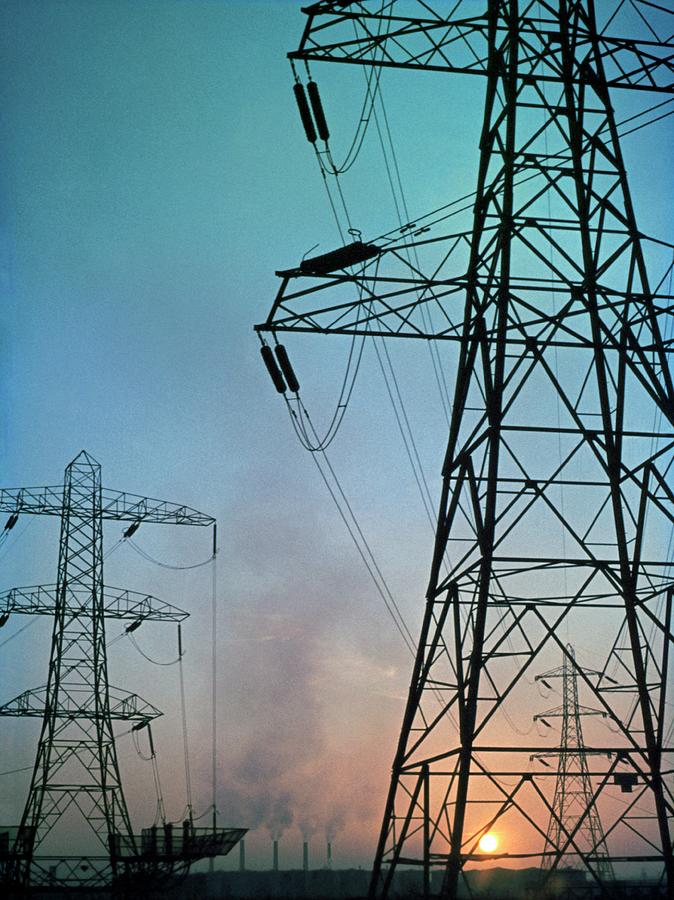 Electricity Pylons At Sunset Photograph by David Taylor/science Photo Library
