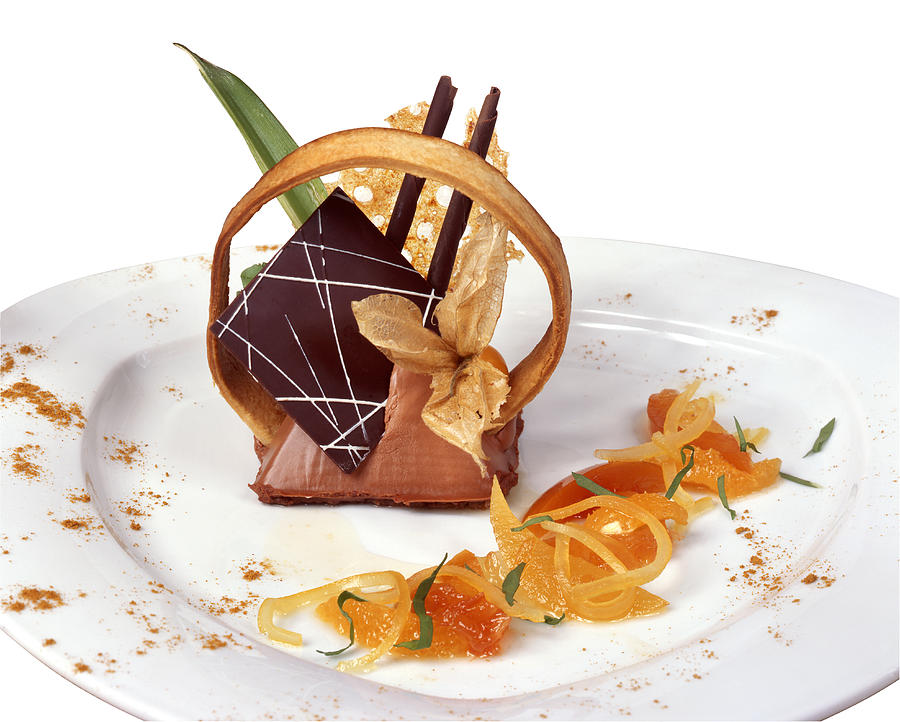 Elegant mousse with many garnishes on a white plate Photograph by Imagestock