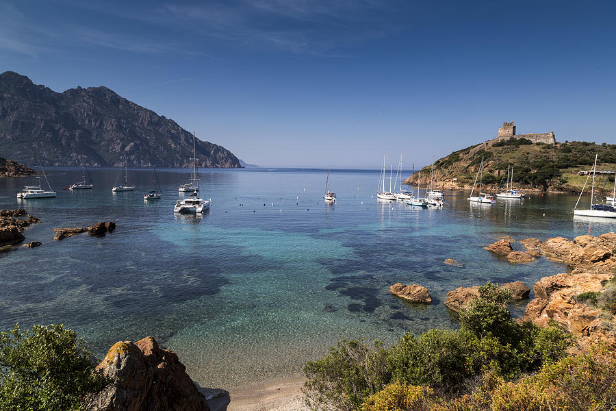 Elevated view of yachts anchored in bay, Girolata, Corsica, France Photograph by Walter Zerla