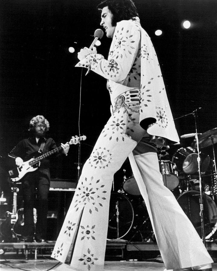 Classic Photograph - Elvis Presley In White Outfit On Stage by Retro Images Archive