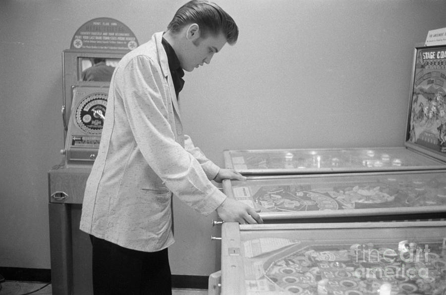 Elvis Presley Photograph - Elvis Presley playing Pinball 1956 by The Harrington Collection