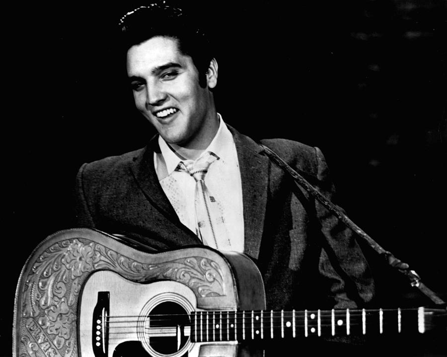 Elvis Presley Photograph - Elvis Presley Smiles While Holding Guitar by Retro Images Archive