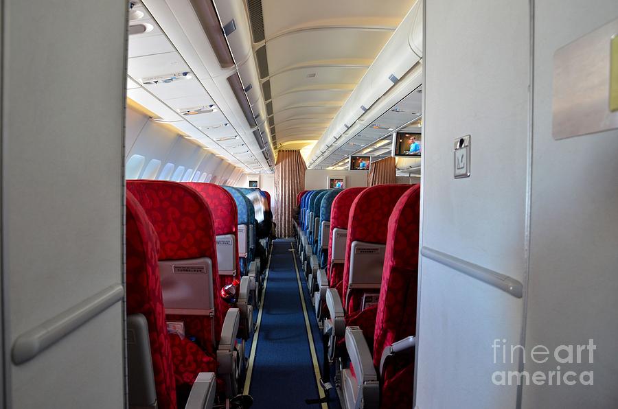 Empty aircraft seats inside airplane cabin Photograph by Imran Ahmed