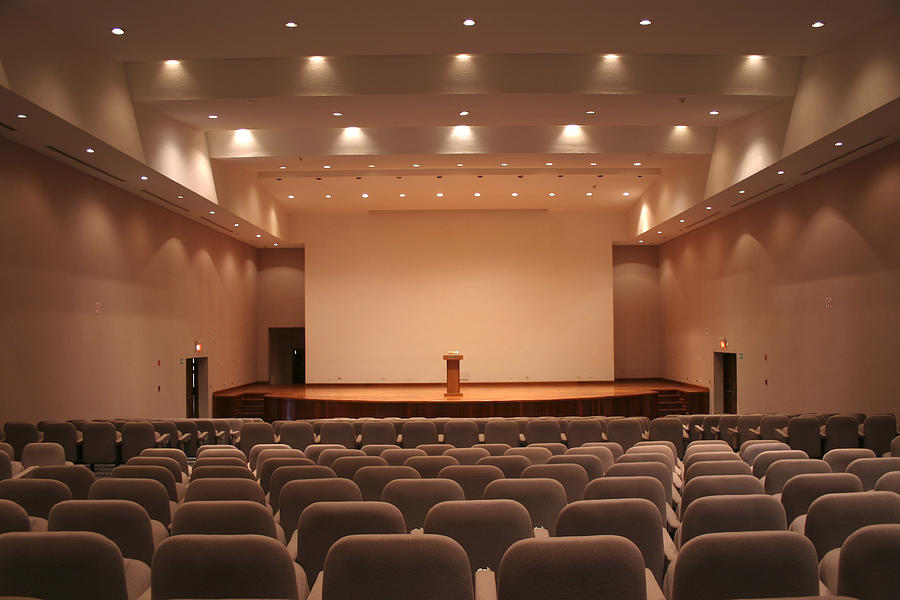 Empty auditorium with grey seats and downlights Photograph by Aleaimage
