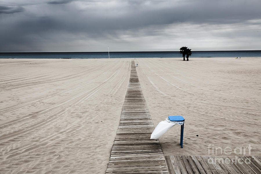 Empty Beach On An Overcast Windy Day With Rubbish Bin Photograph by Peter Noyce