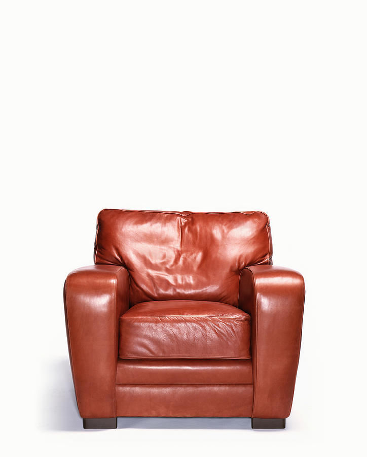 Empty leather armchair Photograph by Peter Dazeley