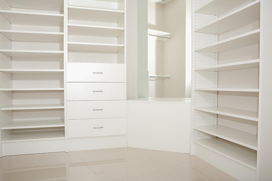 Empty shelves and drawers in modern walk-in closet Photograph by Camilo Morales
