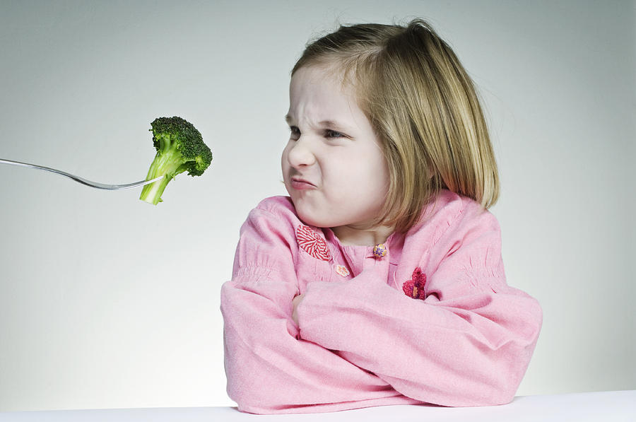 Encouraging Young Girl To Eat Her Greens Photograph by ClarkandCompany