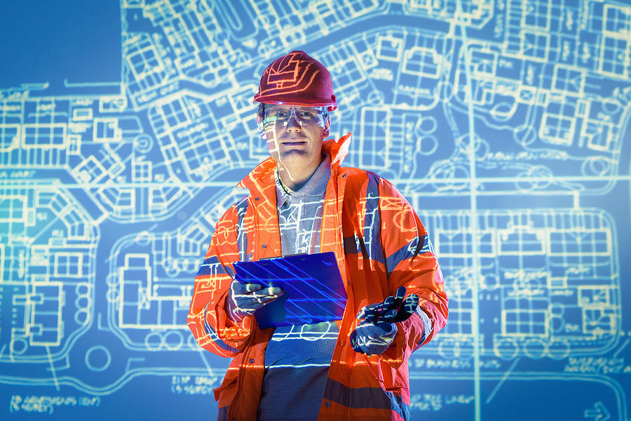 Engineer with digital tablet and projected plans, portrait Photograph by Monty Rakusen