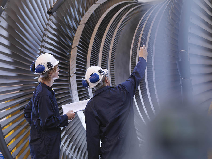 Engineers Looking At Turbine Photograph by Monty Rakusen
