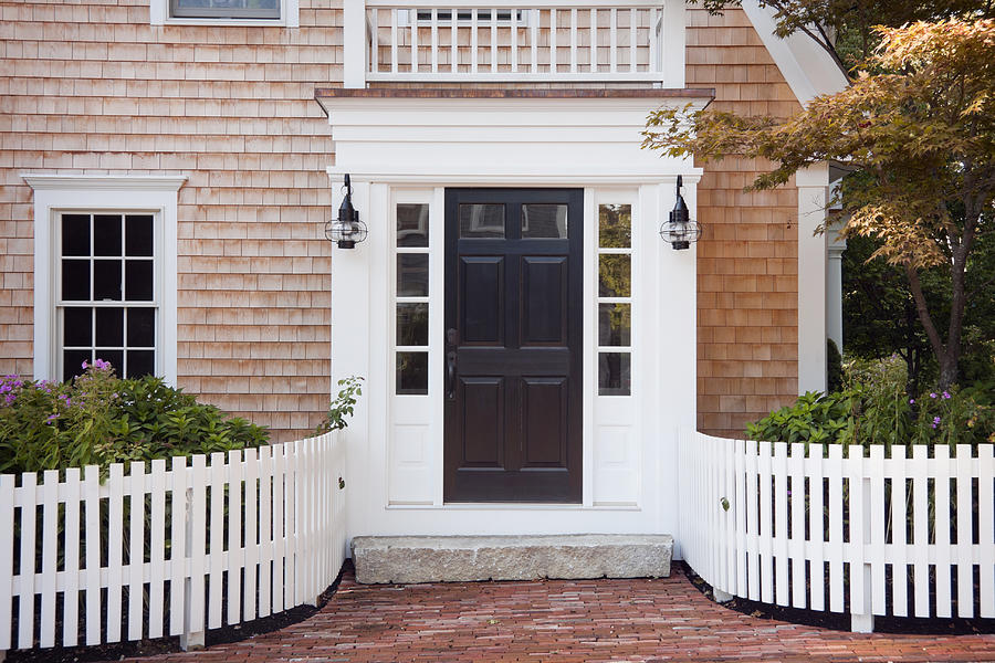 Entryway of brick New England home with picket fence Photograph by Boblin